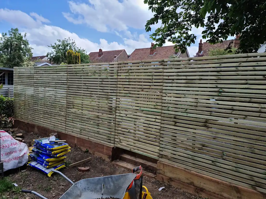 Contemporary slatted timber screening fence installed as a garden boundary by Bracknell Fencing LTD in Berkshire