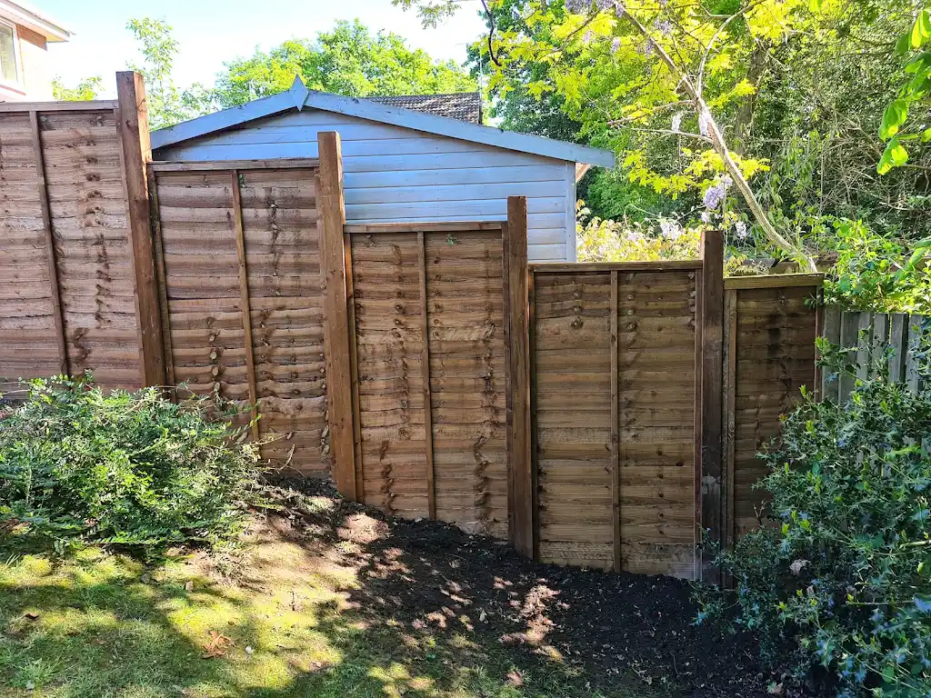 New overlap panel fencing installed between concrete posts and gravel boards by Bracknell Fencing LTD in Berkshire