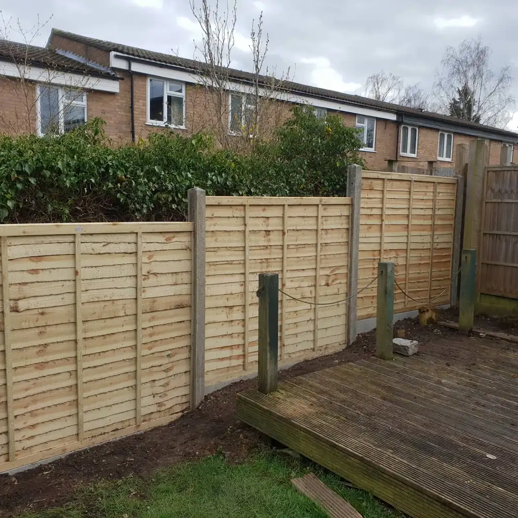 New overlap panel fencing installed between concrete posts and gravel boards by Bracknell Fencing LTD in Berkshire
