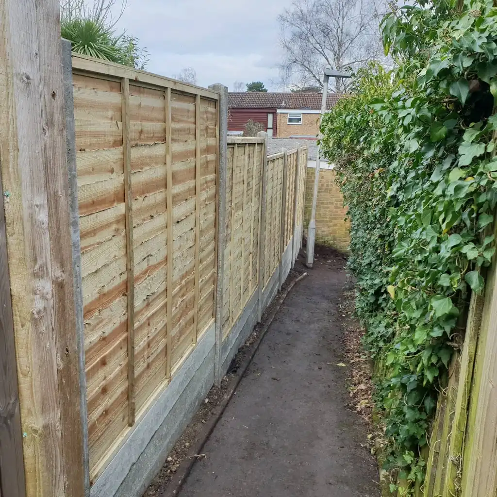 New overlap panel fencing installed between concrete posts and gravel boards by Bracknell Fencing LTD in Berkshire