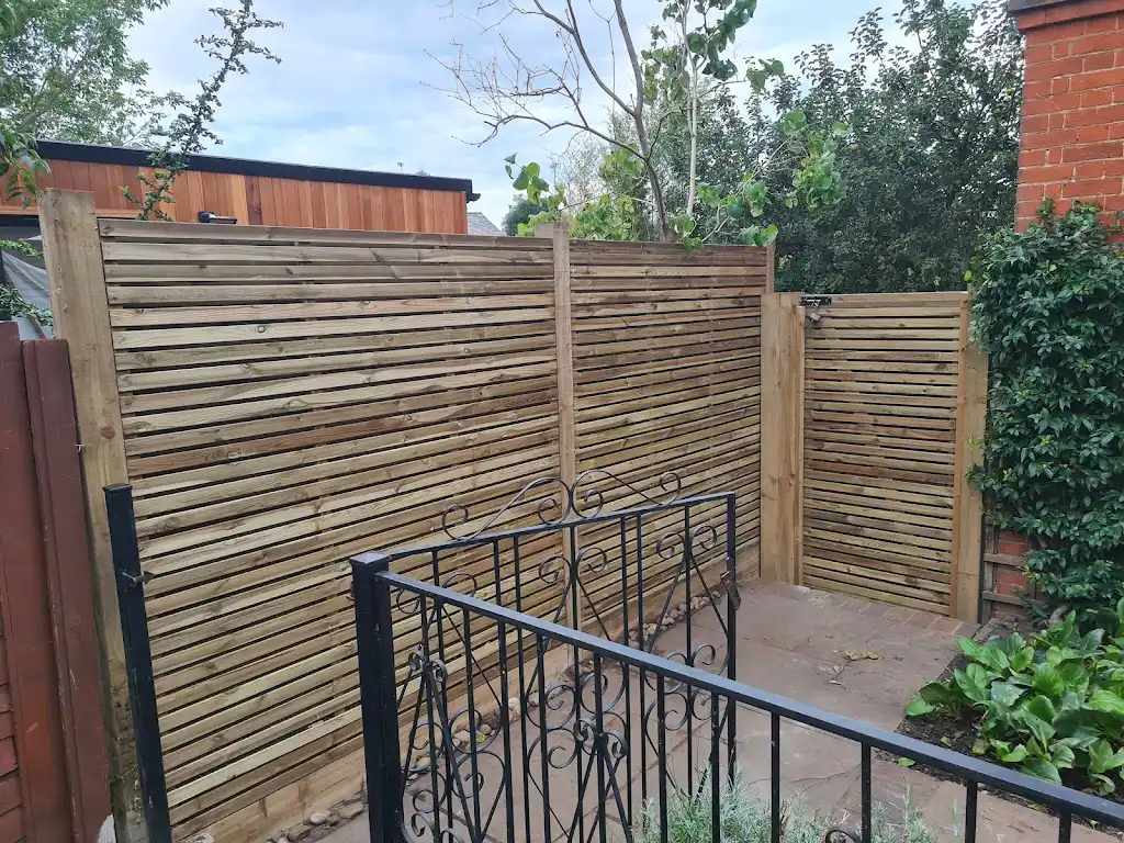 Contemporary slatted timber screening fence installed as a garden boundary by Bracknell Fencing LTD in Berkshire