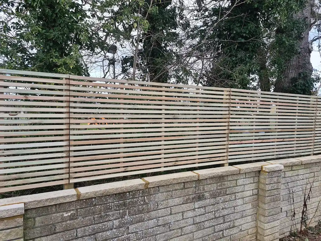 Contemporary slatted timber screening fence installed as a garden boundary by Bracknell Fencing LTD in Berkshire