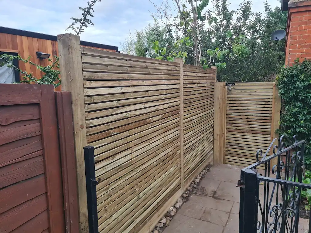 Contemporary slatted timber screening fence installed as a garden boundary by Bracknell Fencing LTD in Berkshire