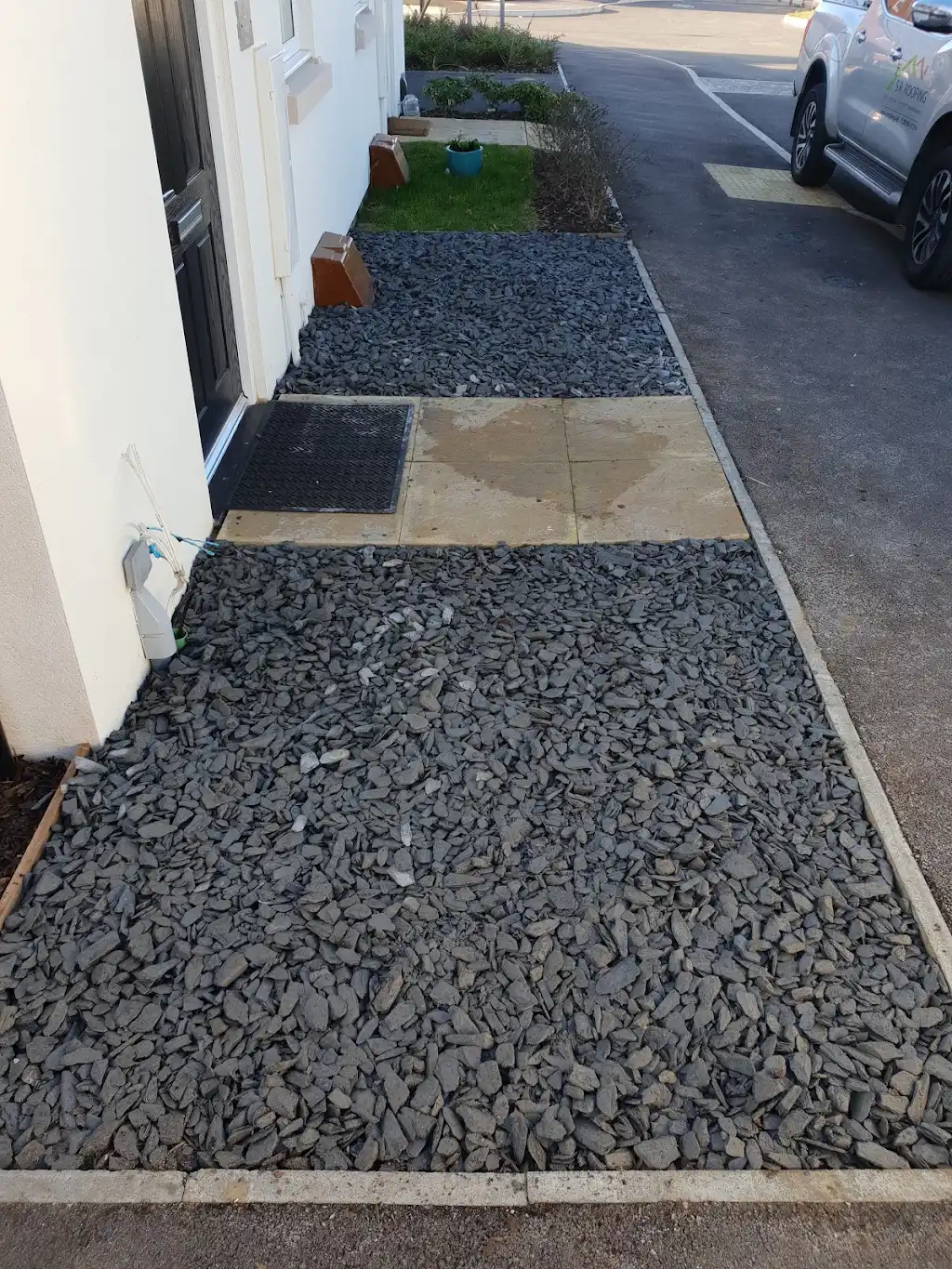Garden landscaping with new lawn, paving and timber sleeper planters by Bracknell Fencing LTD in Berkshire