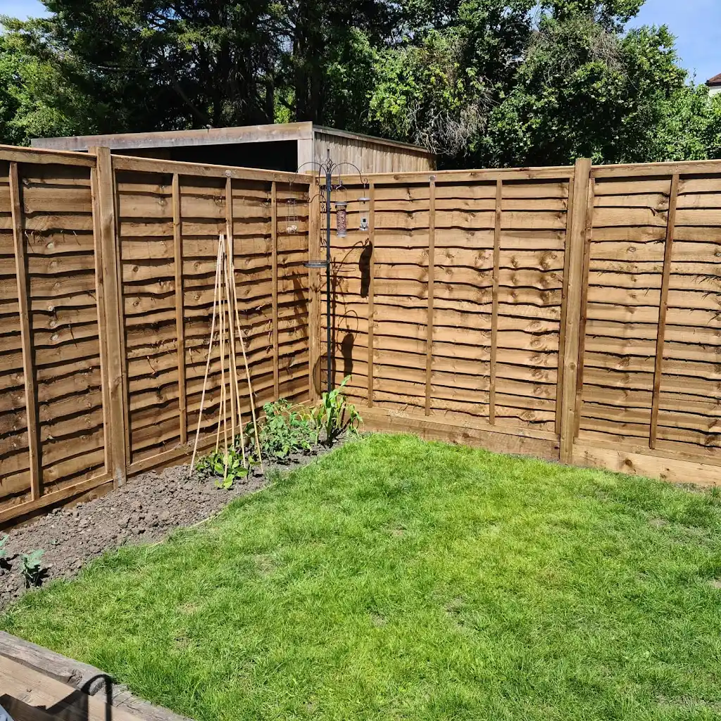 New overlap panel fencing installed between concrete posts and gravel boards by Bracknell Fencing LTD in Berkshire