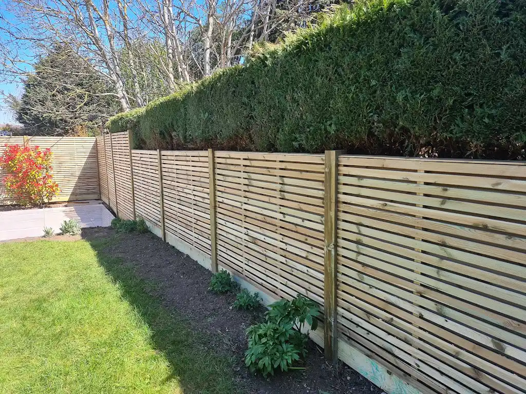 Contemporary slatted timber screening fence installed as a garden boundary by Bracknell Fencing LTD in Berkshire