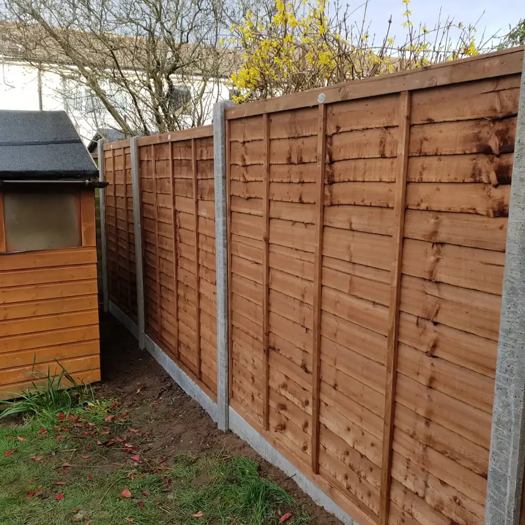 New overlap panel fencing installed between concrete posts and gravel boards by Bracknell Fencing LTD in Berkshire