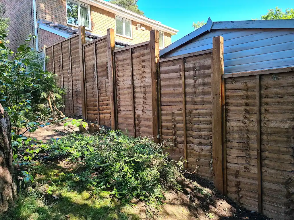 New overlap panel fencing installed between concrete posts and gravel boards by Bracknell Fencing LTD in Berkshire