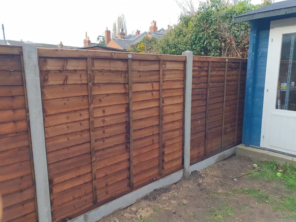 New overlap panel fencing installed between concrete posts and gravel boards by Bracknell Fencing LTD in Berkshire