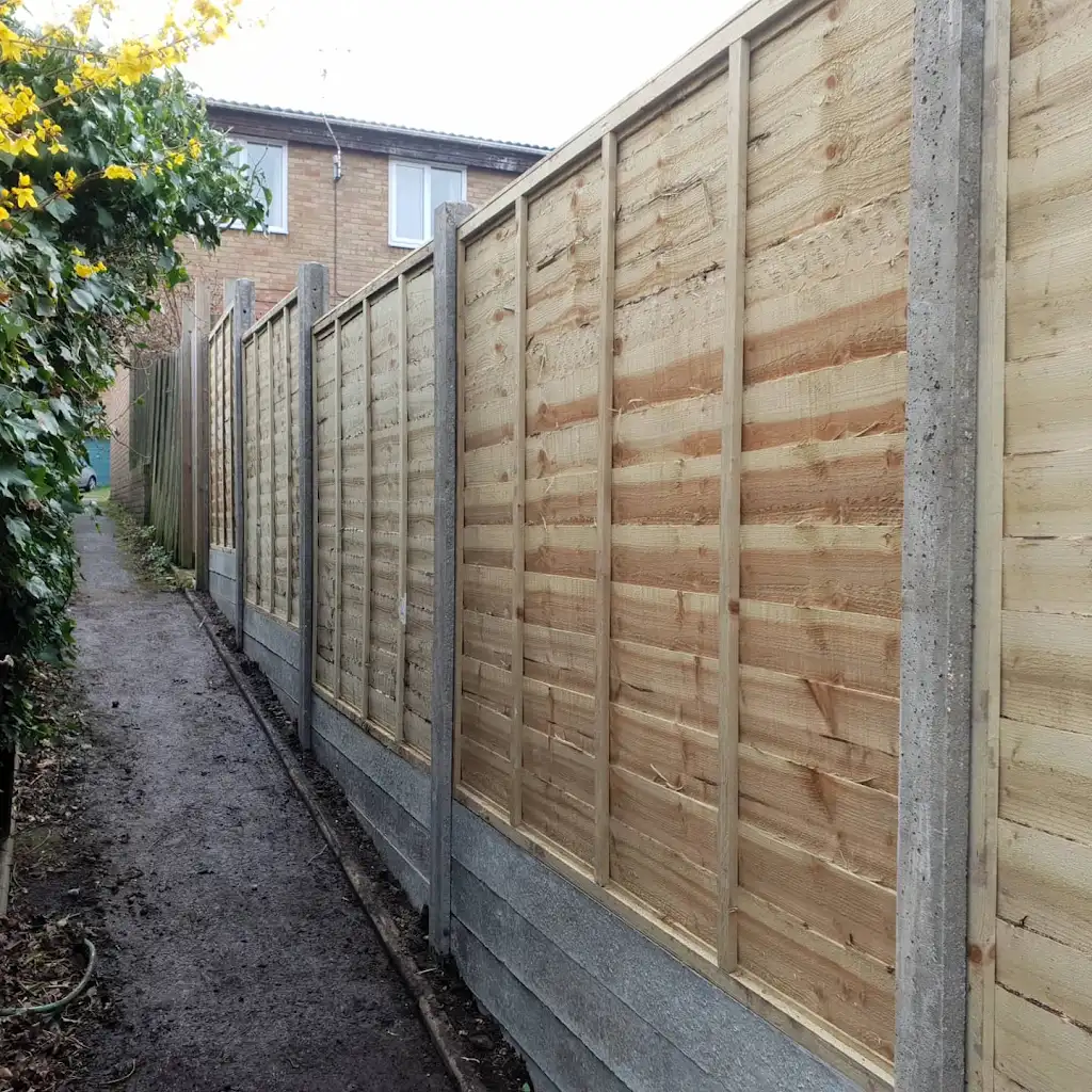 New overlap panel fencing installed between concrete posts and gravel boards by Bracknell Fencing LTD in Berkshire
