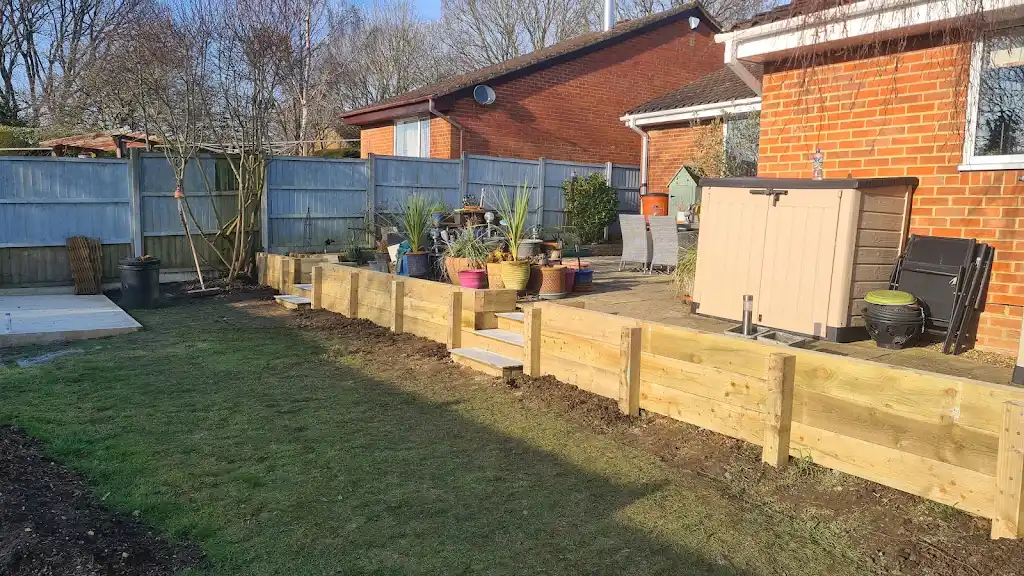 Cleared garden with new timber sleeper retaining border and steps by Bracknell Fencing LTD in Berkshire