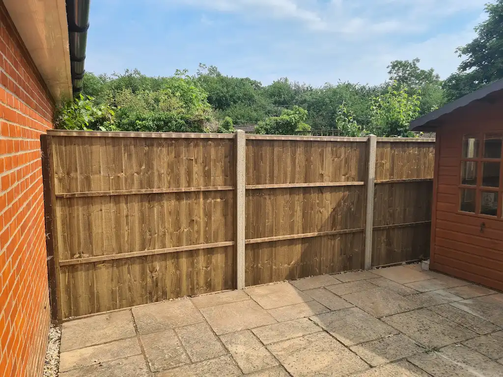New overlap panel fencing installed between concrete posts and gravel boards by Bracknell Fencing LTD in Berkshire