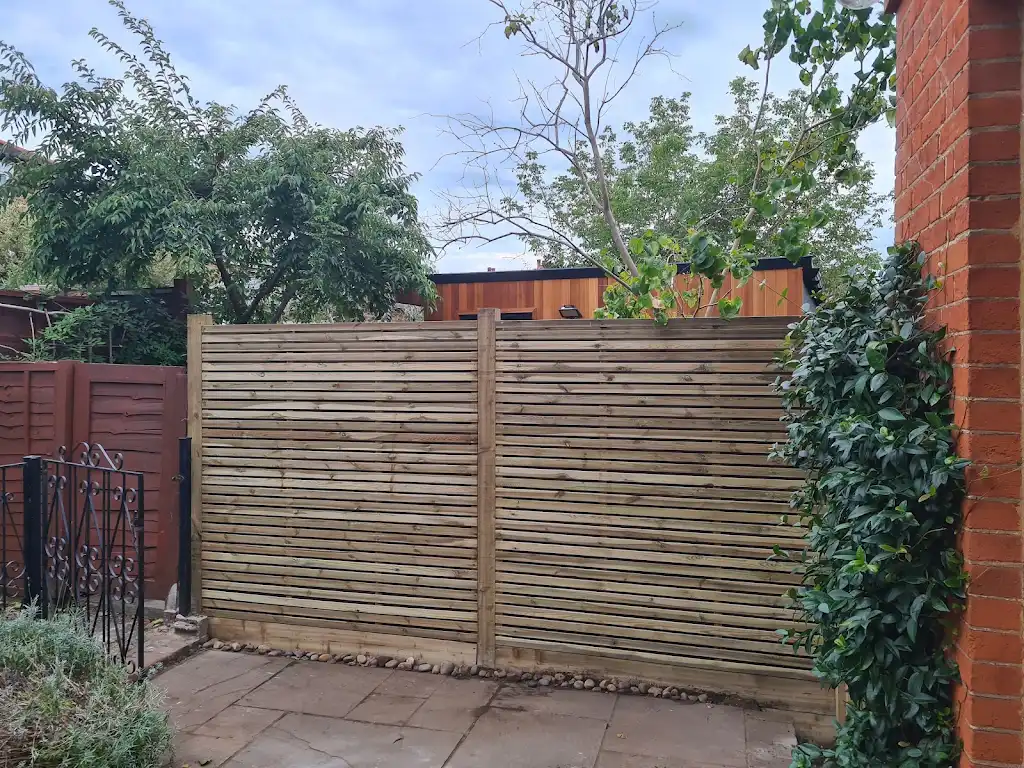 Contemporary slatted timber screening fence installed as a garden boundary by Bracknell Fencing LTD in Berkshire