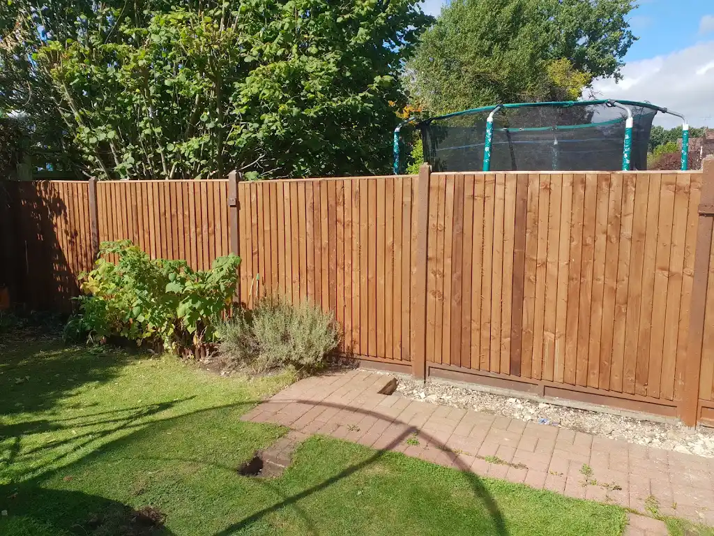 Closeboard featheredge fence panel installed with concrete posts and gravel boards by Bracknell Fencing LTD in Berkshire