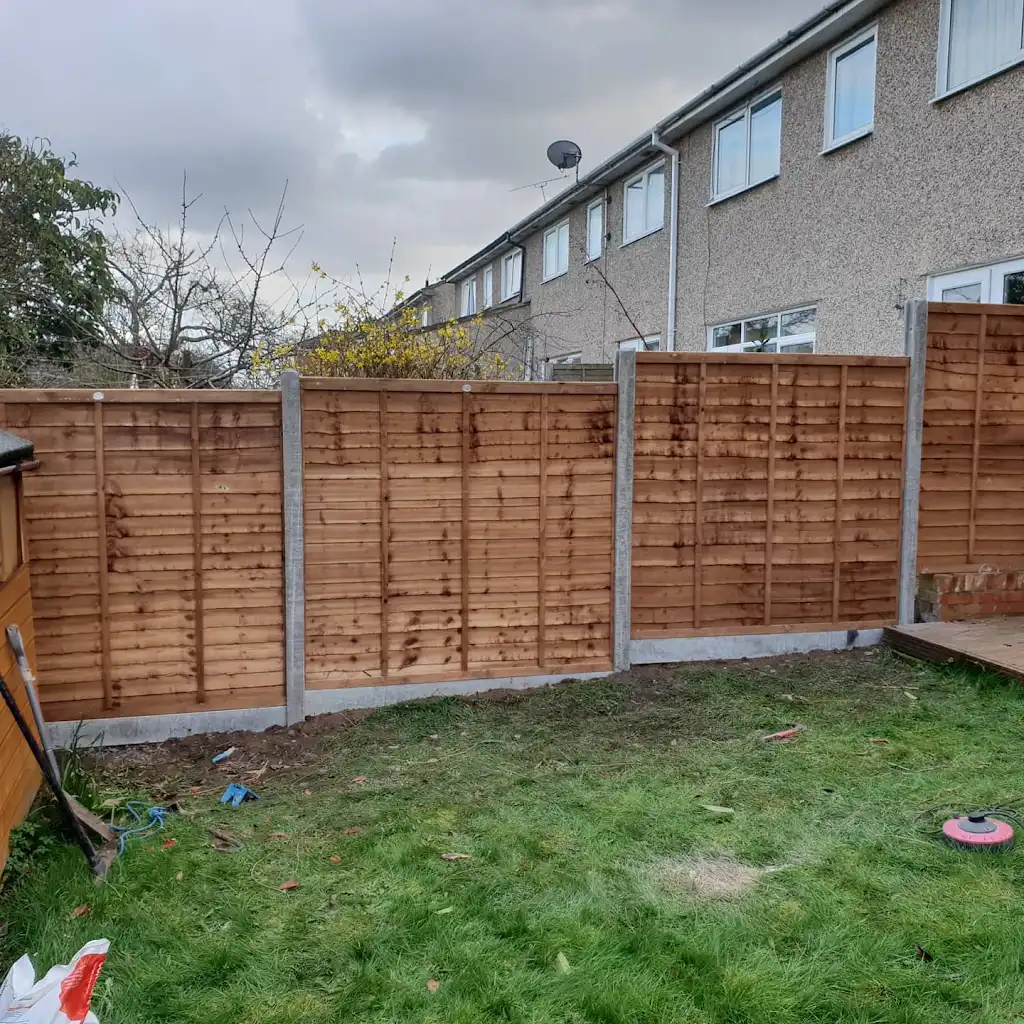 New overlap panel fencing installed between concrete posts and gravel boards by Bracknell Fencing LTD in Berkshire